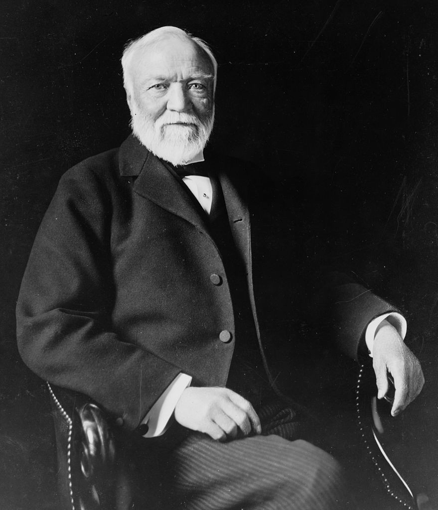 879px-Andrew_Carnegie,_three-quarter_length_portrait,_seated,_facing_slightly_left,_1913 PD